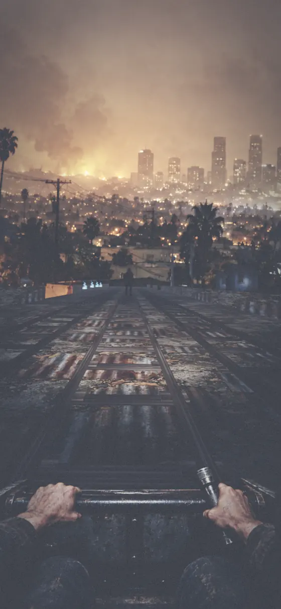 Rails over a night rooftop with a burning city ahead.